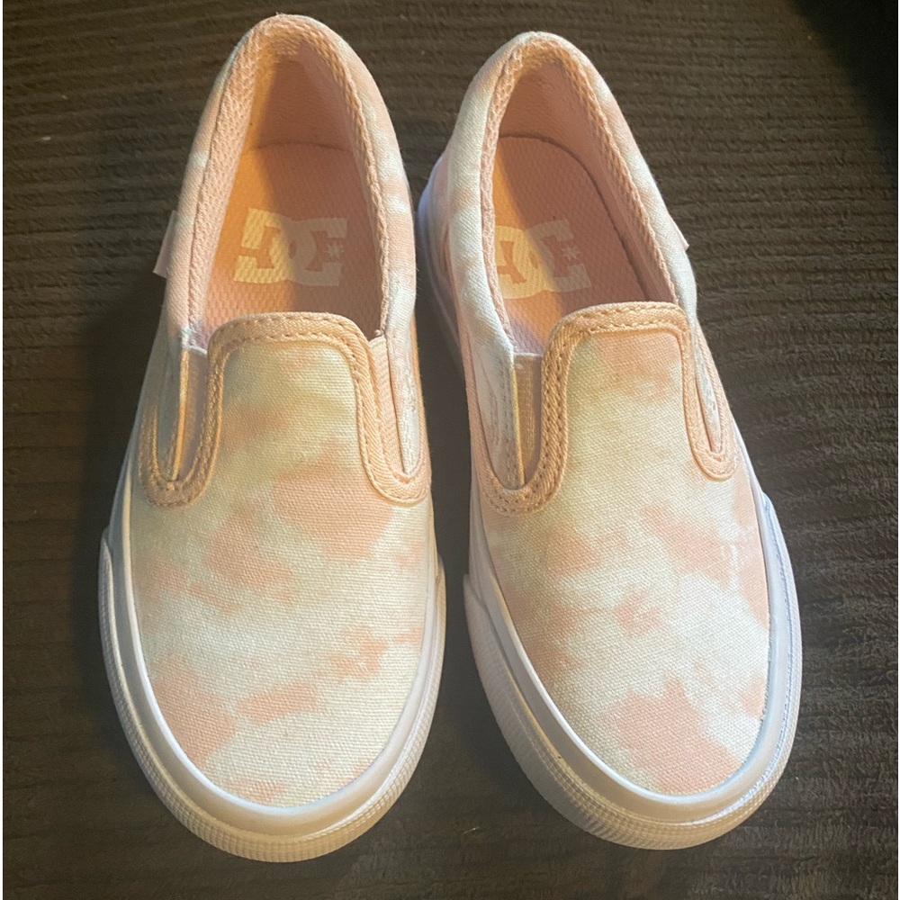 Girls size 11 DC slip on. Brand new from Designer Shoe Warehouse.